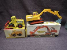 Two Dinky diecasts, 984 Atlas Digger AB1702, in yellow with chrome shovel, orange chassis and