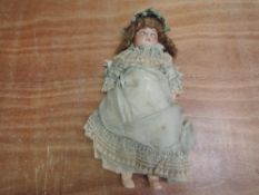 An early 20th century Armand Marseille bisque headed doll having sleep eyes, open mouth with four