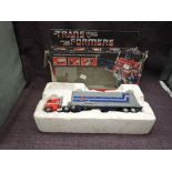 A 1984 Hasbro Bradley Transformers Autobot Commander Optimus Prime, in inner packaging with