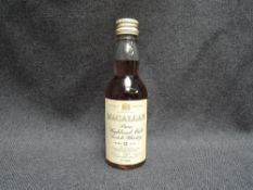 A miniature bottle of Macallan 12 Year Old Pure Highland Malt Scotch Whisky, distilled by Macallan-