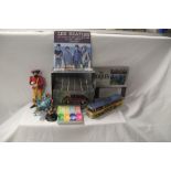 A small lot of Beatles related items with toys and coasters and some small replica guitars on offer