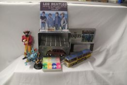 A small lot of Beatles related items with toys and coasters and some small replica guitars on offer