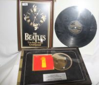 A small Beatles lot including a clock and a copy of the Black and Gold album which has been put into
