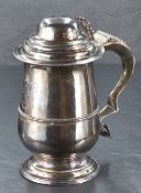 A George III lidded silver tankard, of traditional design, the domed and step-moulded cover with