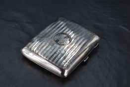 A George V silver cigarette case, of hinged rectangular form curved for the gentleman's pocket and