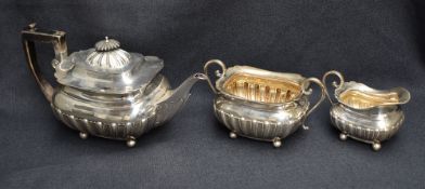 A late Victorian silver three-piece teaset, comprising a teapot, sugar and cream, each of rounded