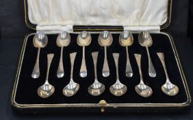 A cased set of twelve George V silver coffee spoons, Old English pattern with pip reverse, marks for