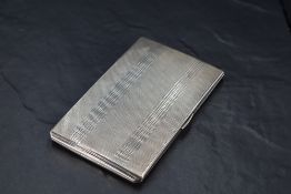 A George VI silver cigarette case, of hinged rectangular form and engine-turned throughout, the