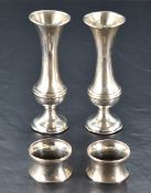 A pair of George V silver spill vases, of flared baluster form with moulded waist and weighted base,