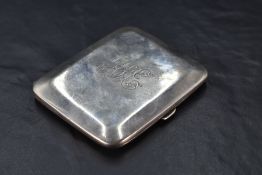 A George V silver cigarette case, of hinged rectangular form with rounded corners and chamfered edge
