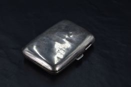 A late Victorian silver cigarette case of hinged rectangular form curved for the gentleman's
