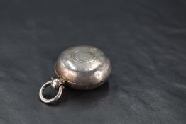 A Victorian silver sovereign holder, of typical hinged circular form with engine-turned decoration