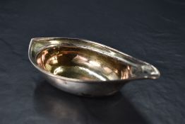 A George III silver sauce boat, of dished elliptical form with moulded rim and pointed spout,