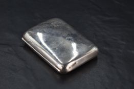 A George V silver cigarette case, of hinged rectangular form curved for the gentleman's pocket and
