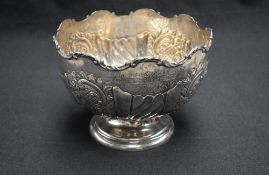 An impressive Edwardian silver punch bowl, with C-scroll moulded rim over engraved presentation