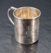 A George V silver christening mug, of cylindrical form with step-moulded rim, scrolled handle and
