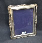 A large early 20th century silver mounted photograph frame, of rectangular form with embossed