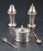 A pair of George VI silver condiments, comprising salt cellar and pepperette, of moulded tapering
