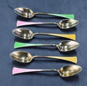 A group of six 1930's silver gilt and enamel coffee spoons, the splayed terminals engine-turned