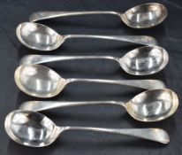 A group of six George V silver Old English pattern soup spoons, with pip reverse and engraved with