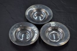 A group of three small Queen Elizabeth II silver alms dishes, of typical dished circular form with