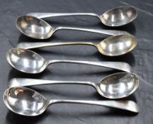 A group of six George V silver Old English pattern soup spoons, with pip reverse and engraved with