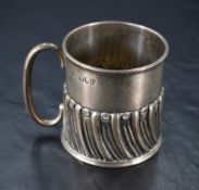 A Victorian silver mug, of cylindrical form with simple tubular loop handle and half gadrooned body,