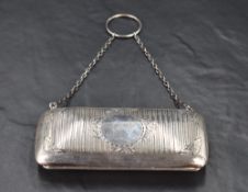A George V silver purse, of hinged and rounded oblong form with engraved foliate and wriggle-work