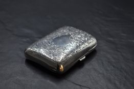 An Edwardian silver cigarette case, of hinged rectangular form, curved for the gentleman's pocket