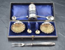 A pair of late Victorian silver salts, of scallop shell form with three ball feet and simple spoons,