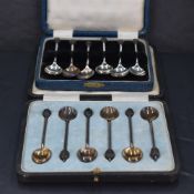 A cased set of six George V silver coffee bean spoons, each with oval bowls and traditional
