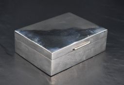A Queen Elizabeth II silver cigarette box, of plain hinged rectangular form with pronounced lip