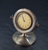 A George V silver desk clock, the circular dial with Arabic hours and marked 'Swiss' within an