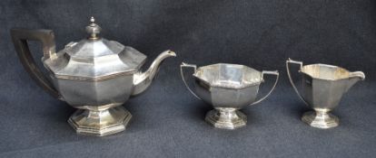 A George V silver three-piece teaset, comprising teapot, sugar and cream, each of octagonal form