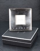A Queen Elizabeth II silver Concorde branded photograph frame, of square form with broad silver '