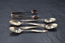 A group of four George VI silver coffee spoons, of Art Deco design with matching sugar tongs,