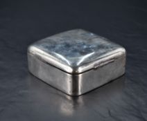 An Edwardian silver cigarette box, of rounded and slightly domed square section form with serpentine