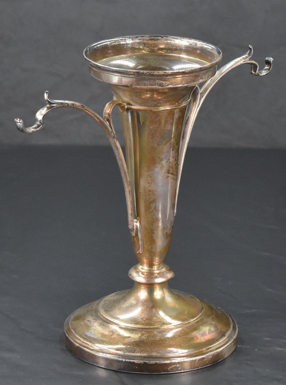 A George V silver epergne, of moulded and tapering cylindrical form flanked by sinuous brackets (