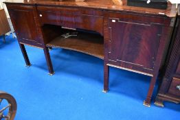 A late 19th or early 20th Century mahogany sideboard having central drawer and shelf, flanked by