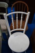 A traditional painted bentwood chair and a hoop and stick back dining chair