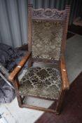 A Period oak throne style chair having stuffed seat and back