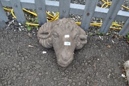 A concrete garden ornament modelled as sheep or goats head
