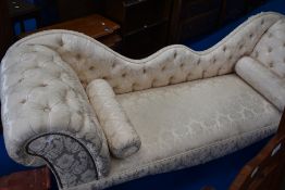 A reproduction double ended chaise longue having cream upholstery