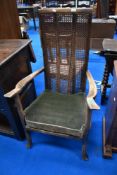 An early 20th Century stained frame armchair having bergere cane back and seat