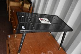 A vintage tile top coffee table on dansette style splay legs, small proportions approx W56 D34