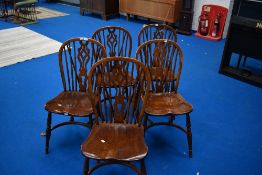 A set of five traditional Windsor style dining chairs having crinoline stretchers