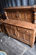 A traditional mid/dark stain Ercol or similar buffet sideboard