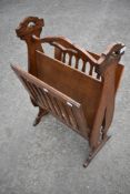 A patented oak magazine rack of interesting design, possibly Arts and Crafts