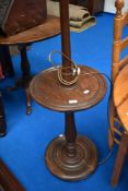 An early 20th Century mahogany standard lamp with integral table and handkerchief style fabric