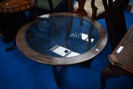 A vintage teak G plan style circular coffee table having drop in glass top